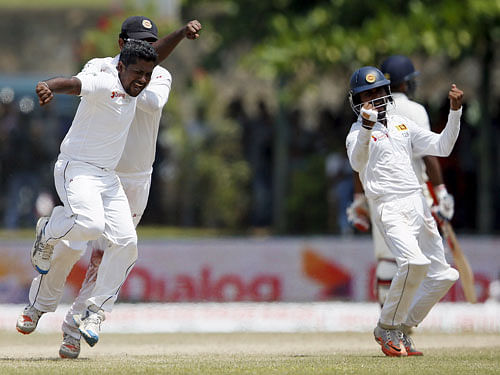 Sri Lanka's Herath celebrates with his teammates after taking the wicket of India's Rahane on the fourth day of their first test cricket match in Galle. Reuters Photo.