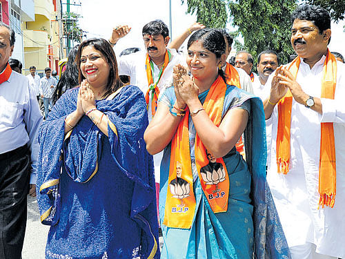 STAR POWER: Actor Rakshita (second from left) and former deputy chief minister R&#8200;Ashoka (extreme right) campaign for  D&#8200;H Lakshmi (third from left), the BJP&#8200;candidate from Ganesha Mandira ward on Saturday. dh Photo