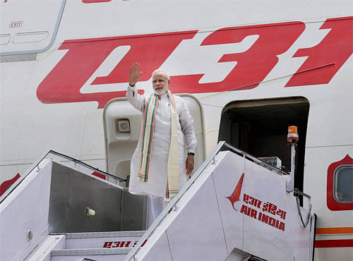 Prime Minister Narendra Modi waves before his departure from New Delhi on Sunday for the UAE. PTI Photo