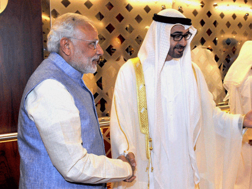 Prime Minister Narendra Modi being welcome by Crown Prince of Abu Dhabi Sheikh Mohammed Bin Zayed al Nahyan on his arrival in Abu Dhabi on Sunday. PTI Photo