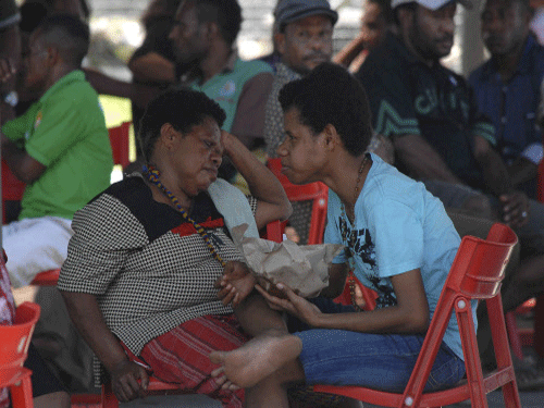 Family members of passengers on board the crashed Trigana Air flight wait for information at Sentani Airport near Jayapura, Papua province, Indonesia. A team of rescuers, including troops and police, were heading to the area on foot but will have to battle through dense forest to reach the remote site. Reuters photo