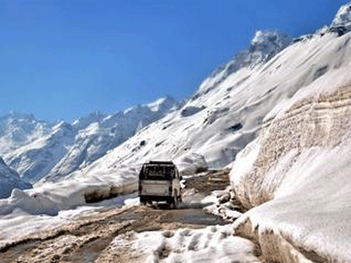 A vehicle passing through the snow-covered Rohtang Pass in Manali. PTI file photo