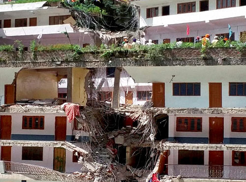 A collapsed building after a big boulder fell over it in Gurdwara Manikaran in Kullu district of HP on Tuesday. PTI Photo
