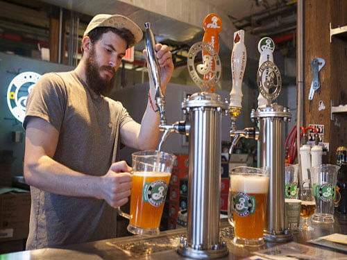 Tim Lappin, a tour guide, pours beer to be sampled at the Brooklyn Brewery in New York. Brooklyn Brewery, the craft beer maker operating from New York City's most populous borough, resisted taking money from investment firms for almost three decades, according to founder Steve Hindy. Now the brewer of Brooklyn Lager is having second thoughts. Reuters file photo