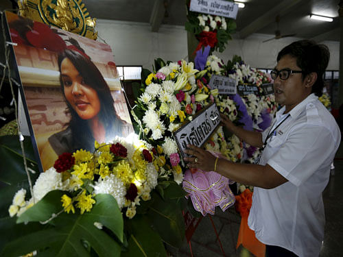 Relatives look at a picture of Thai victim from Monday's bomb blast, Waraporn Changtam, while praying during a Buddhist funeral at a temple in Nonthaburi province. Reuters File Photo.