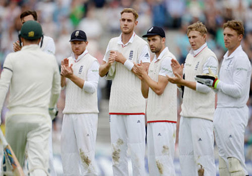 England players applaud as Australia's Michael Clarke receives a guard of honour Reuters
