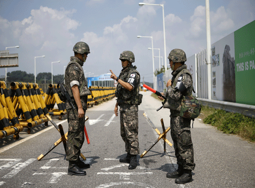 South Korean soldiers talk next to barricades at a checkpoint on the Grand Unification Bridge which leads to the truce village Panmunjom, just south of the demilitarized zone separating the two Koreas, in Paju. Reuters photo