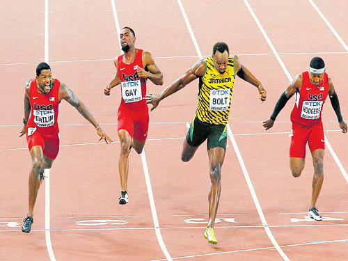 close shave: Jamaican Usain Bolt (second from right) sneaks just ahead of American Justin Gatlin (left) to retain his 100M gold in the World Championships on Sunday. reuters