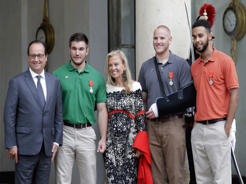 French President Francois Hollande awarded France's highest honour, the Legion d'honneur, to three U.S. citizens and a Briton who helped disarm a machine gun-toting attacker on a Thalys train last week. Reuters photo