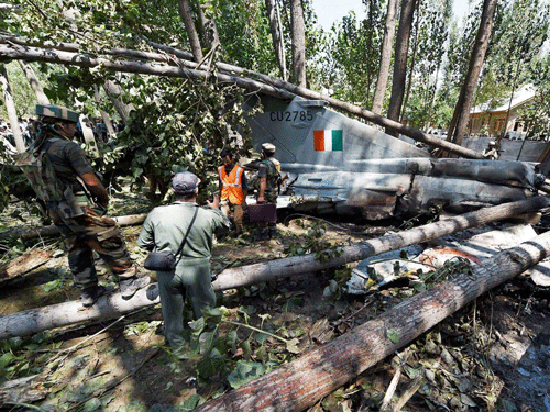 Disaster response personnel check the wreckage of an Indian Air Force MiG-21 Bison aircraft that crashed in Soibugh on the outskirts of Srinagar on Monday. PTI