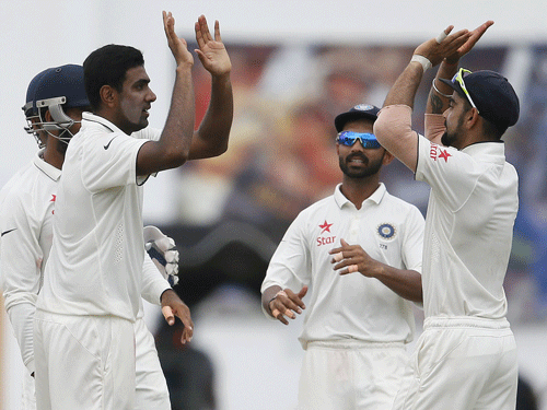 India's Ravichandran Ashwin (2nd L) celebrates with captain Virat Kohli (R) and Ajinkya Rahane (C) after taking the wicket of Sri Lanka's Dimuth Karunaratne (not pictured) during the fifth day of their second test cricket match in Colombo August 24, 2015. Reuters Photo.