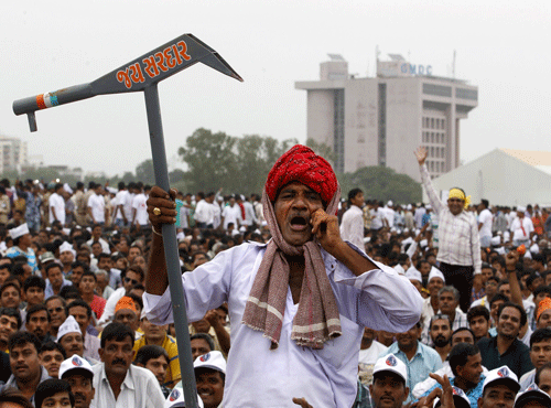A member of the Patel community holding a mock scratch plough shouts slogans during a protest rally in Ahmedabad. Reuters photo