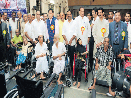 Beneficiaries were given wheelchairs during the programme organised by Bearys' Cultural Forum at Loyola Hall, Mangaluru, on Sunday. DH photo