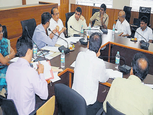 District In-charge Minister Vinay Kumar Sorake chairs a meeting in Udupi on Monday. DH photo