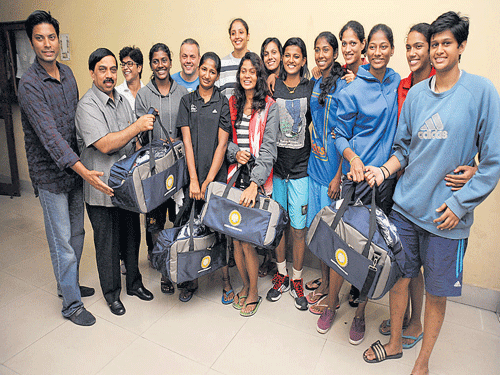 realistic goals CEO of AirAsia India Mittu Chandilya (left) and President of the Karnataka Olympic Association K Govindaraju (second from left) present sports kit to Indian women basketball players before their depature to China for the Asian Championships in Bengaluru on Tuesday. (From left): Aparna Ghosh (assistant coach), Anitha, Francisco Garcia (coach), Bhandavya, Rajapriyadharshini, Sitamani, Smruthi, Poojamol, Anjana, Stephy Nixon, Apporva, Jeena, Shireen Vijay. DH photo