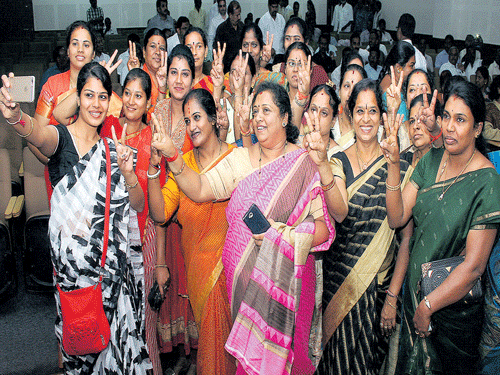 Newly elected BJP corporator from Hosahalli constituency R Mahalakshmi (extreme left) takes a selfie with  other women corporators from her party during a meeting in the City on Wednesday. DH photo