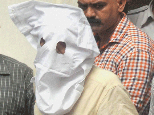 Sanjeev Khanna (covered face), former husband of Indrani Mukerjea, being produced in a local court for his alleged involvement in the murder of Sheena Bora, in Kolkata on Thursday. PTI Photo