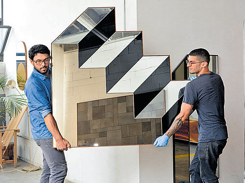 Tammer Hijazi (right), and Danny Giannella, the co-founders of Bower, carry a mirror in their New York shop.