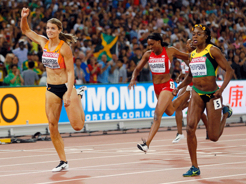 Dafne Schippers of the Netherland (L) crosses the finish line to win the women's 200m final ahead of Elaine Thompson of Jamaica (R) during the 15th IAAF World Championships at the National Stadium in Beijing, China, August 28, 2015. REUTERS
