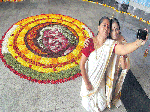 Women take selfie near a pookalam paying tribute to late  A P J Abdul Kalam in Mumbai on Thursday. PTI