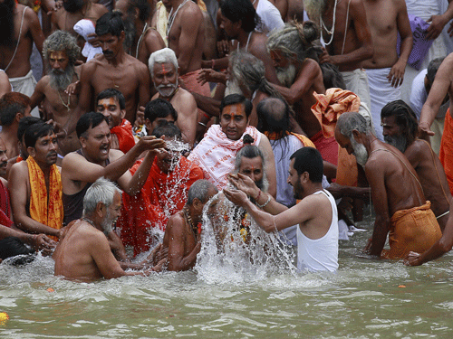 Sadhus or Hindu holy men take a dip in the Godavari river during the first 'Shahi Snan' (grand bath) at 'Kumbh Mela', or Pitcher Festival in Nashik. Reuters File Photo