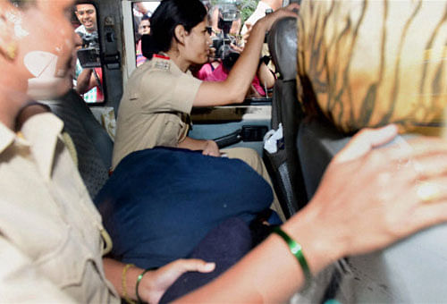 Indrani Mukerjea (hiding herself between two lady constables) being taken to an unknown place from the Khar police station in Mumbai. PTI file photo