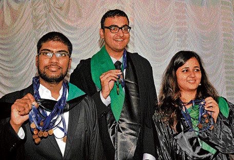 Gold medalists (from left) Shiva Santosh Kumar Y, Vansh Sharad Gupta and Mansi Sood share a happy moment at the 23rd annual convocation at the National Law School of India University campus on Sunday. dh photo