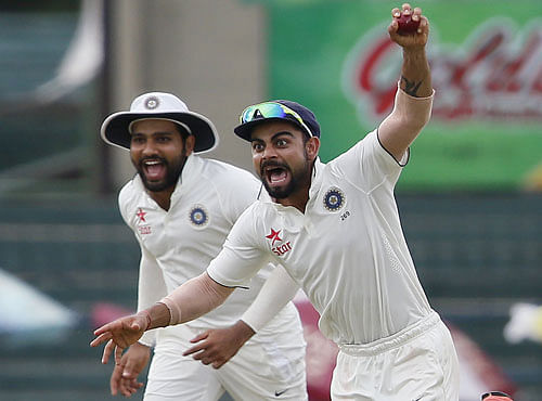 India's captain Kohli celebrates with Sharma after taking the catch to dismiss Sri Lanka's Chandimal during the fourth day of their third and final test cricket match in Colombo. Reuters photo