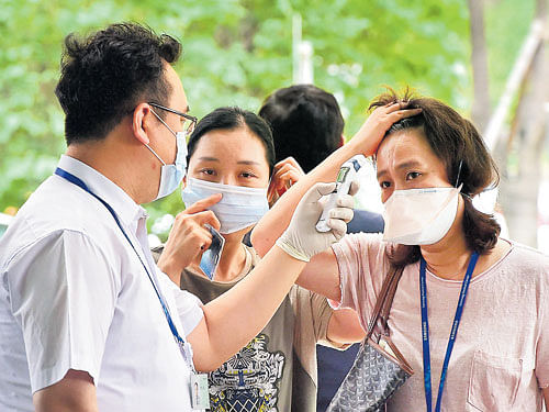 combat ready: A hospital worker in Seoul screens visitors for symptoms during a MERS outbreak. Researchers have proposed the creation of a global vaccine-development fund, supported by governments, pharmaceutical companies and philanthropies. nyt