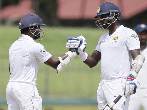 Sri Lanka's captain Angelo Mathews (R) and Kusal Perera celebrate their partnership during the final day of their third and final test cricket match against India in Colombo , September 1, 2015. REUTERS Photo