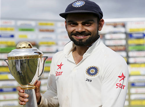 India's captain Kohli poses for photographs with the trophy after they won their final test cricket match and the series against Sri Lanka in Colombo. Reuters photo