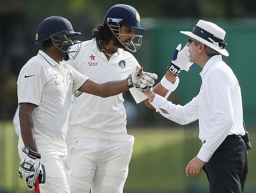 Umpire Llong speaks with Ishanth Sharma after an argument between Sharma and Sri Lanka's bowler Prasad during the fourth day of their third and final test cricket match in Colombo. Reuters