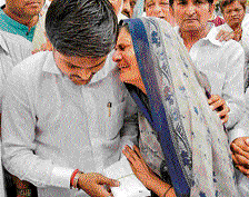Prabhaben Patel, mother of Shwetang Patel, weeps as Hardik Patel consoles her in Ahmedabad on Thursday. PTI