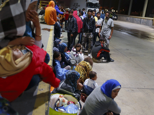 Migrants rest at the Austrian-Hungarian border station of Hegyeshalom, Hungary. Reuters