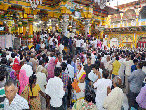 Devotees gather at Dwarkadheesh temple to offer prayers on the occasion of Janmashtami festival in Mathura on Saturday. PTI Photo.