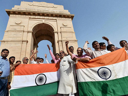 Ex-servicemen celebrate at the India Gate after the government announced the implementation of One Rank One Pension (OROP) scheme, in New Delhi on Saturday. PTI Photo