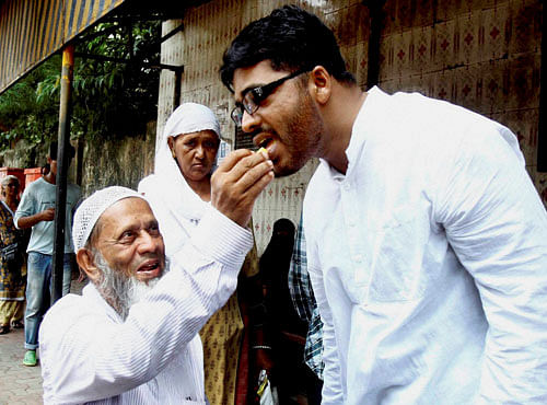Abdul Wahid Deen Mohammed Shaikh is offered sweet by his family member after he was released from Arthur Road Jail in Mumbai on Saturday. Shaikh was accused in 2006 serial blasts. PTI Photo