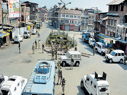 Security men at Nowhatta Chowk during restrictions following a strike call given by separatist and religious groups in protest against the beef ban in Srinagar on Saturday. PTI