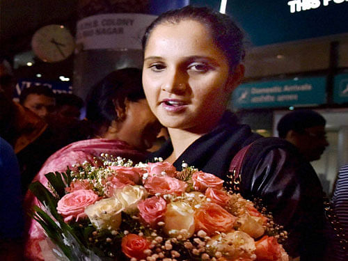 Tennis Star Sania Mirza arrives after winning her second consecutive Grand Slam title US Open women's doubles at Rajiv Gandhi International Airport in Hyderabad on Tuesday. PTI Photo