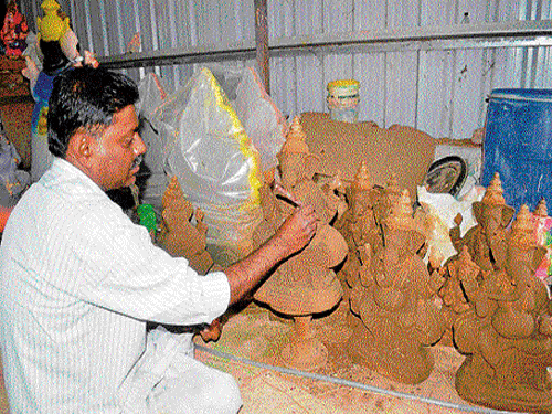 Eco-friendly: Muniraju making clay idols of Ganesha, at Halahalli, in Mandya. DH&#8200;photo