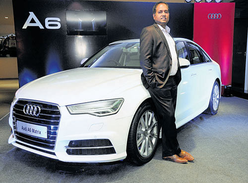 Gajanan Hegdekatte, Business Head, (Sales and Marketing), Audi Bengaluru, is seen next to a new Audi A6 Matrix during its launch in Bengaluru recently.