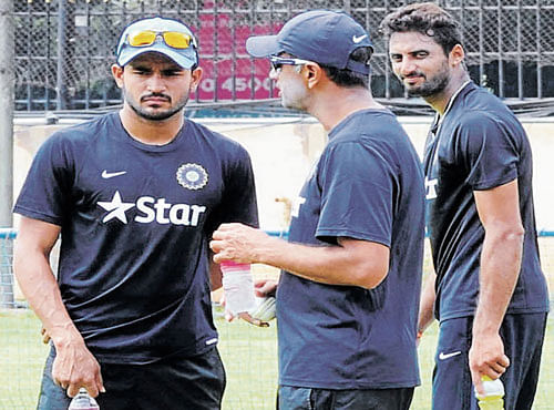 GEARING UP: India 'A' playersManish Pandey (left) and Sreenath Arvind (right) listen to coach Rahul Dravid at the nets.