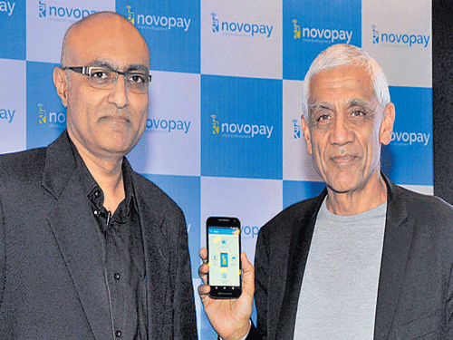 Vinod Khosla, Chairman of Khosla Ventures, USA (right), launches the 'Novopay' Consumer payment app in Bengaluru on Wednesday, as Novopay Chairman Srikanth Nandhamuni looks on. DH PHOTO BY B K JANARDHAN