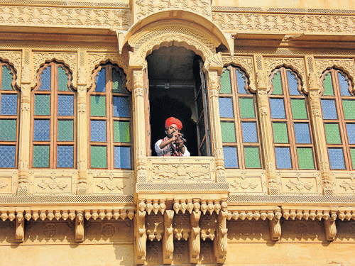 History in every corner  A 'manganiyar' musician  seated in a 'jharoka';  (below) cenotaphs of Silk Route traders in Thar.