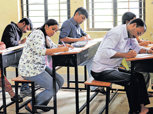 Candidates writing KPSC examination at the VHD Central  Institute of Home Science in Bengaluru on Sunday. dh photo