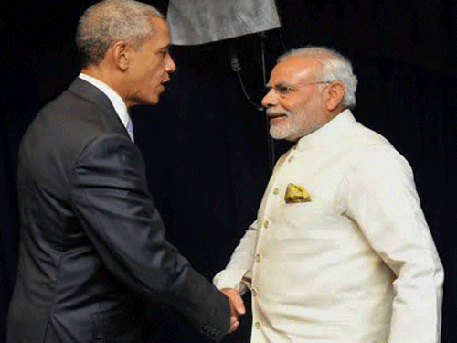 comrades in arms: Prime Minister Narendra Modi shakes hands with US President Barack Obama in New York on Monday. PTI