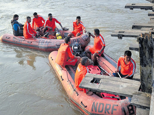 NDRF team searches for bodies after a motor boat capsized  in Kalahi River at Samfupara in Kamrup district of Assam on Monday. PTI