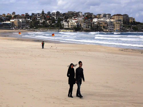 Tourists walk along the sand at Bondi beach in Sydney, Australia. Reuters File Photo.