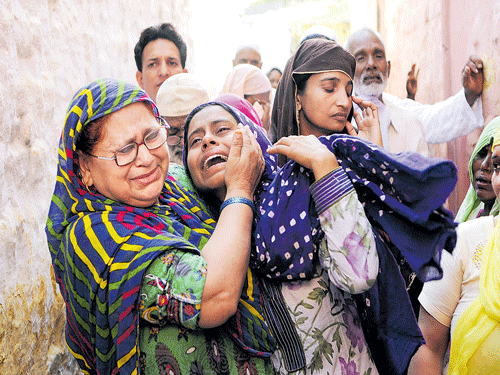 Relatives mourn Mohammad Akhlaq, a 50-year-old who was beaten to death over rumours that he had eaten beef, in Bisada, 35 km from New Delhi. Akhlaq was dragged out of his house and attacked by around 100 people on Monday. AFP