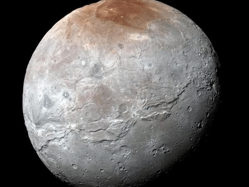 New close-up views of Pluto's moon Charon show a colorful & violent history. Photo courtesy:NASA
